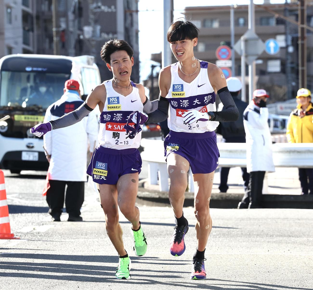 戸塚中継所で駒大8区山川（左）は9区菅谷にタスキをつなぐ（撮影・宮地輝）