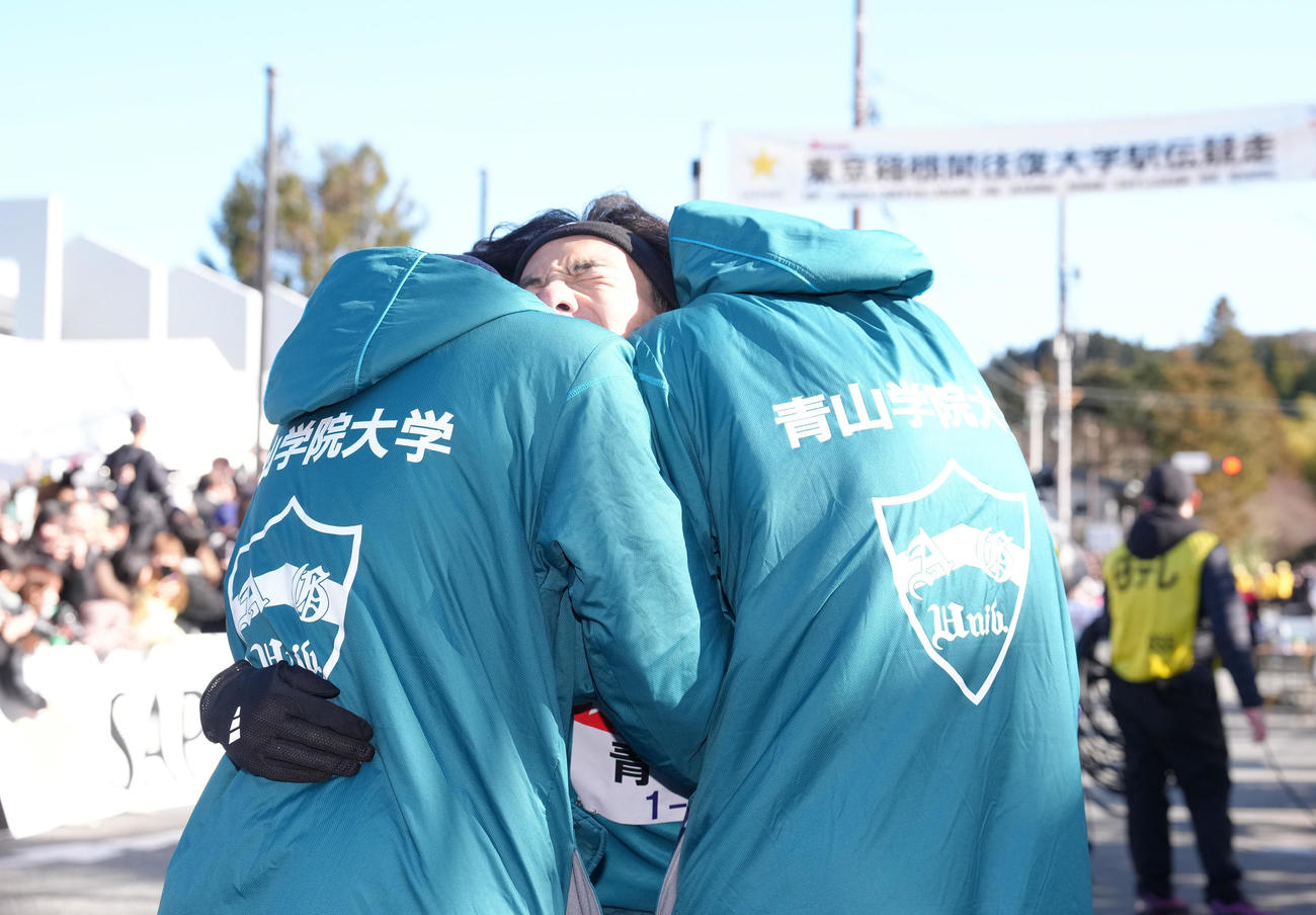 区間新記録でチームを往路優勝に導き抱き合い喜ぶ青学大5区黒田（中央）（撮影・足立雅史）