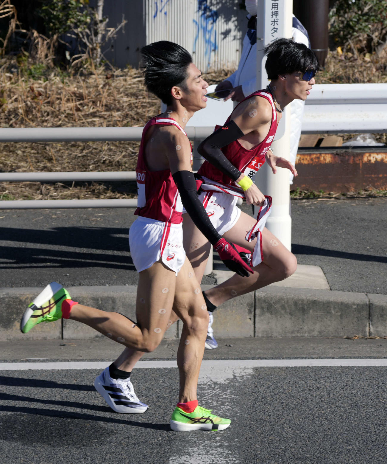 平塚中継所に向かう帝京大7区柴戸（左）は松井にタスキをつなぐ（撮影・小島史椰）