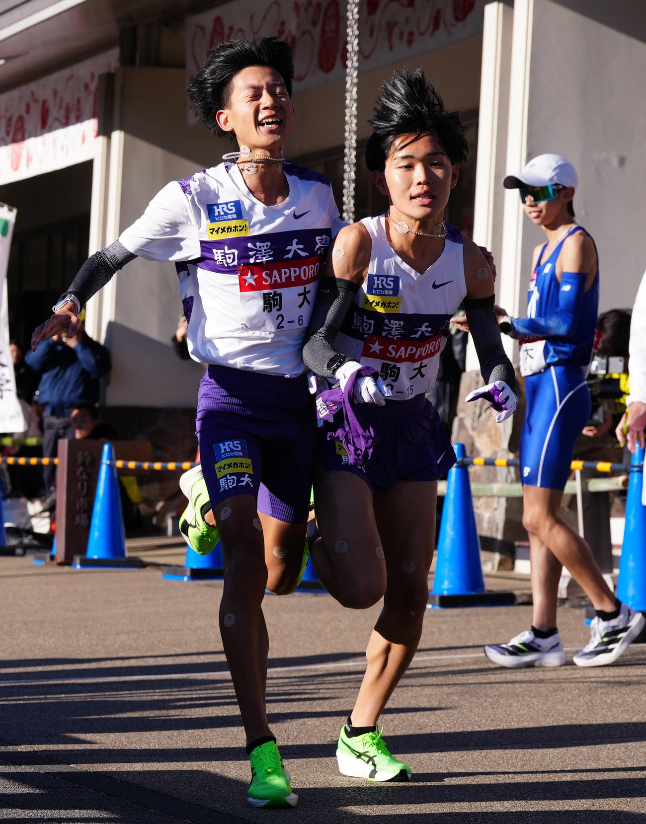 小田原中継所で7区谷中（右）にたすきを渡す駒大6区伊藤（撮影・鈴木みどり）