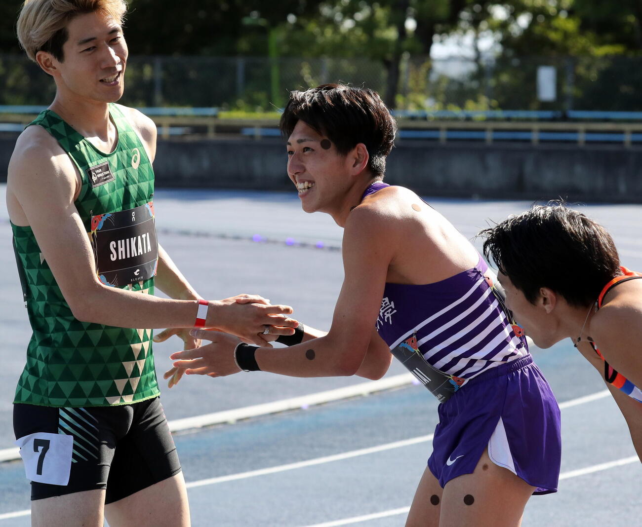 男子800メートルの日本新記録1分43秒45をマークし、祝福される落合晃（撮影・木下淳）