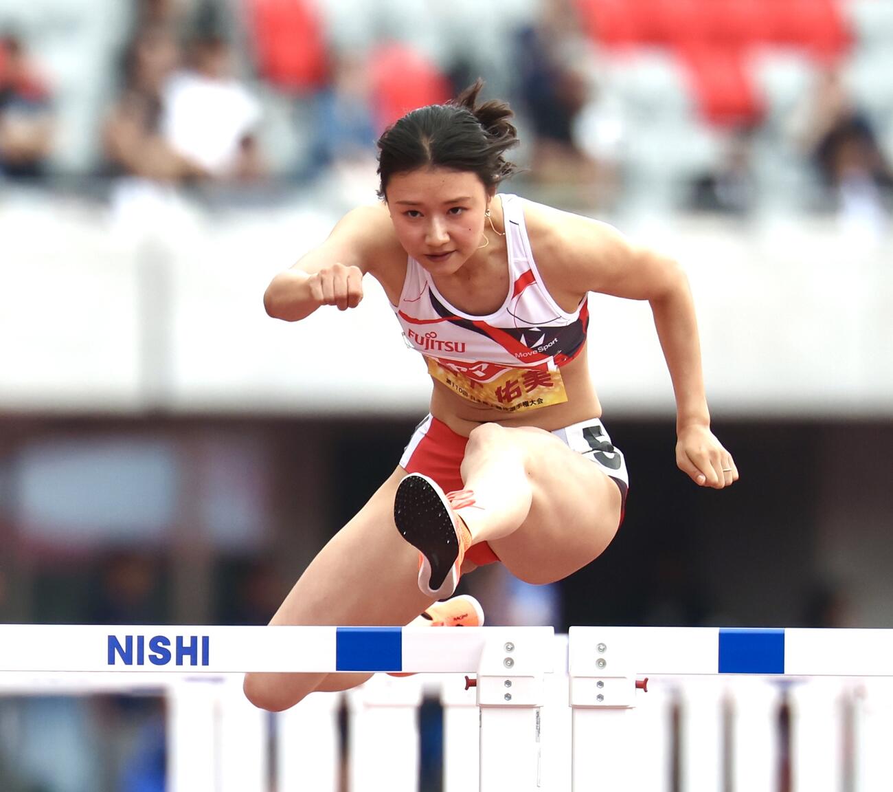 第110回日本陸上競技選手権大会　第1日　女子100メートル障害予選　ハードルを越える田中佑美（撮影・宮地輝）