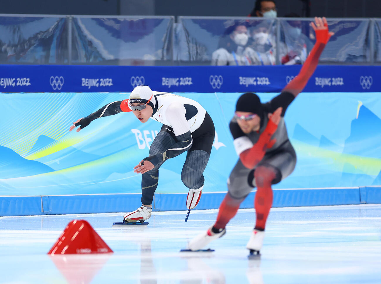 2022年2月、北京五輪スピードスケート男子500メートル、スタート直後、出遅れる新浜（左）