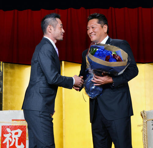 殿堂入りパーティーで佐々木主浩氏（右）に花束を贈呈するイチロー
