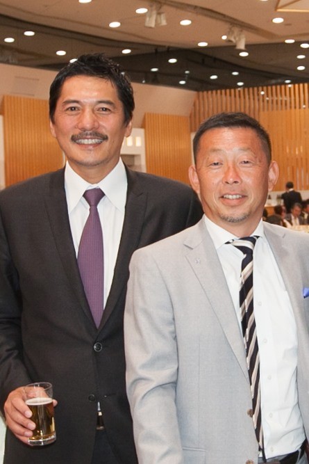 14年5月に開かれた伏見工山口総監督の祝賀会で記念撮影する高崎氏（右）と平尾さん（高崎氏提供）