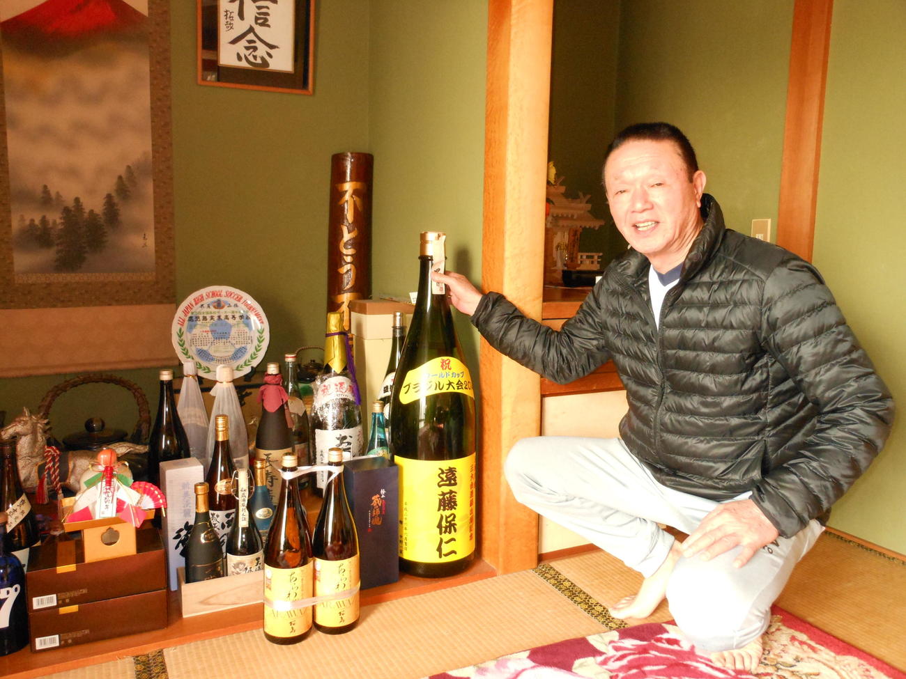 遠藤の実家では父武義さんが過去のお祝いの焼酎を多数飾っている
