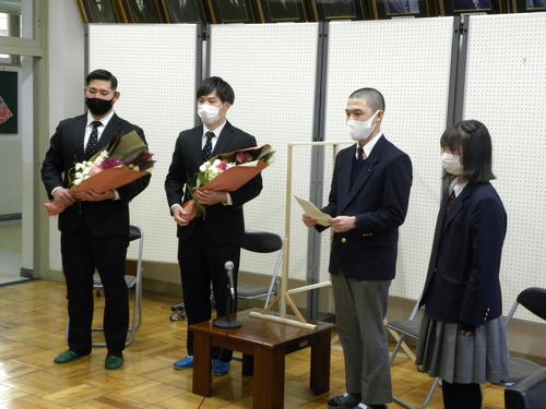 日新高の生徒会から花束を受け取った天理大ラグビー部の市川敬太（左から2人目）と柿本敬治郎（左）（撮影・松本航）