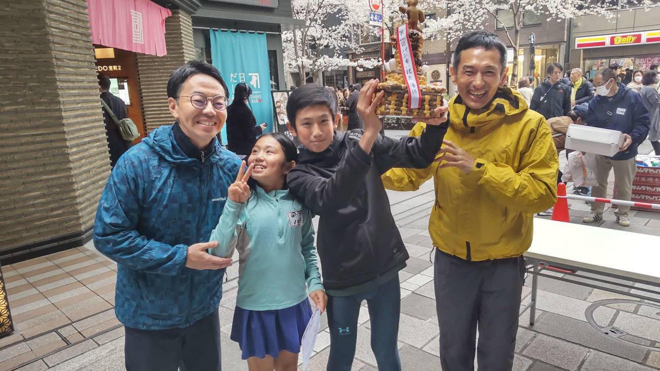優勝した岡部航一君（右から2人目）を祝福する木村光伯社長（左）と為末大さん（右）