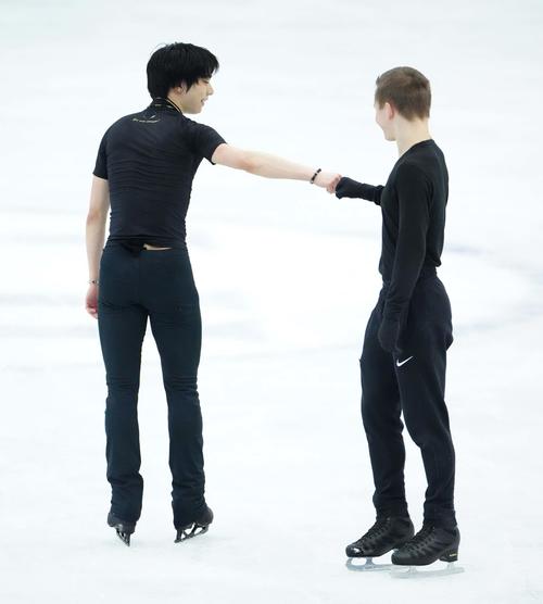 4回転アクセルに挑戦した羽生結弦（左）は練習を終えコリヤダとこぶしを合わせる（代表撮影）