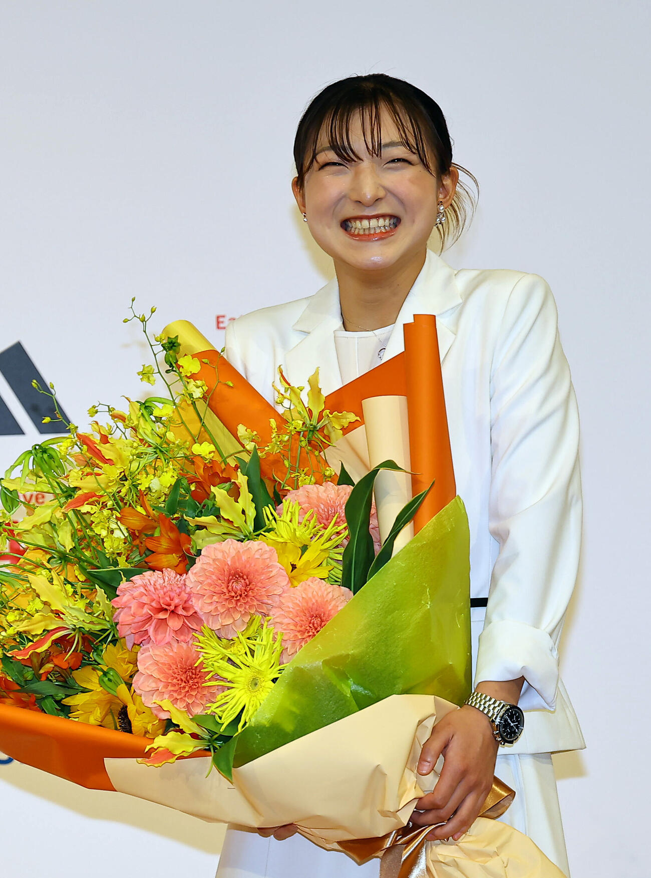 2026年5月、引退会見で結婚を発表し、花束を手に笑顔を見せる坂本花織さん
