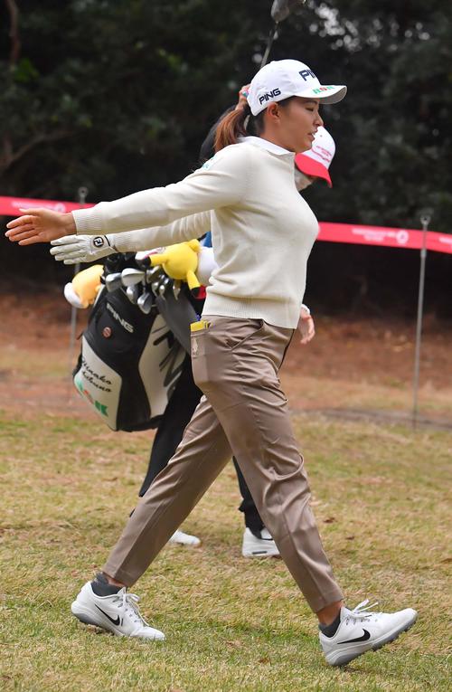 プロアマ戦に参加し、肩のストレッチをしながら歩く渋野日向子（撮影・上田博志）