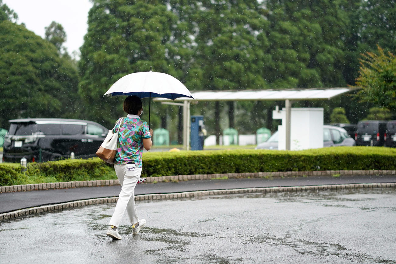 降雨によるコースコンディション不良のため、最終日は29日に順延となり、傘を差し引き揚げる原江（Getty　Images／JLPGA提供）