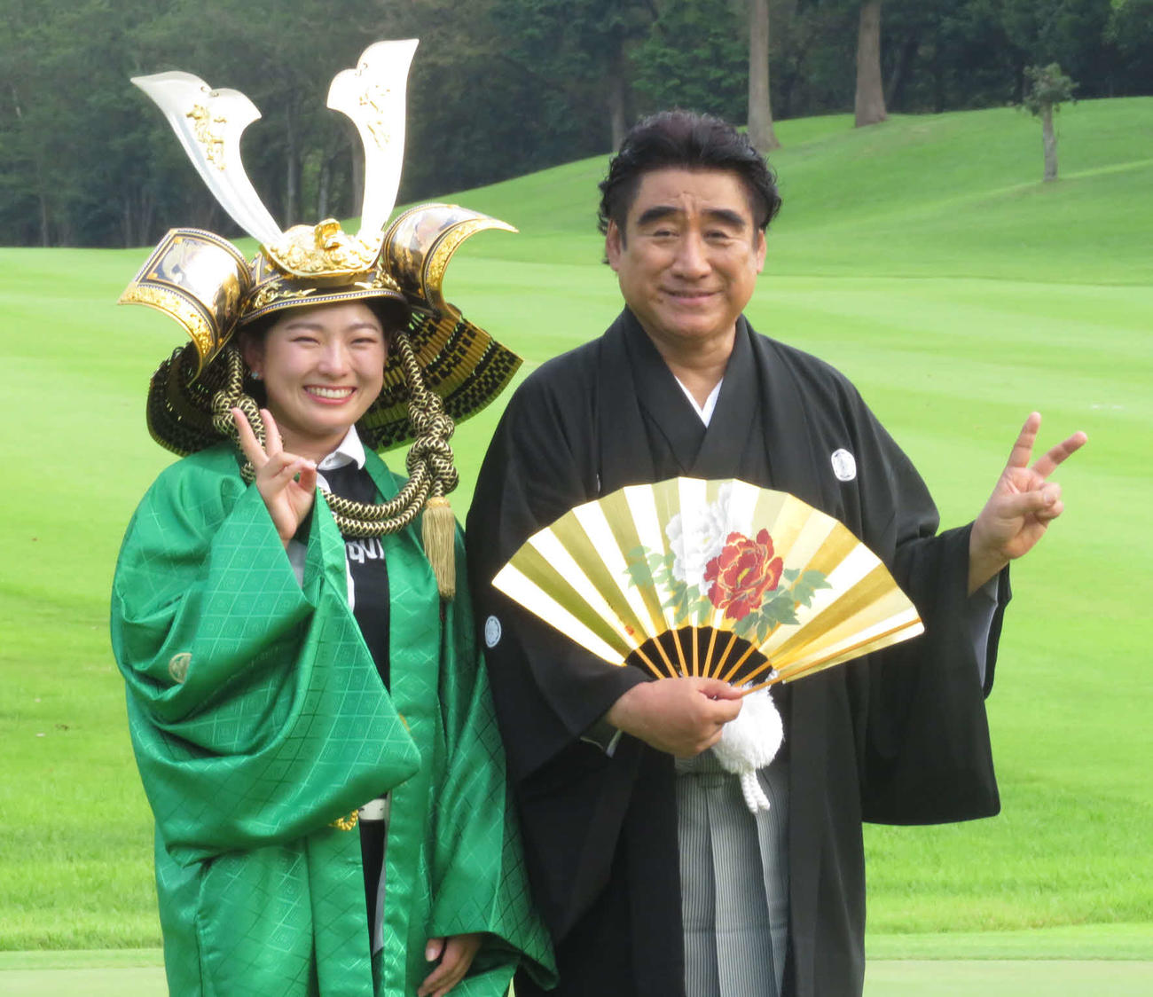 優勝者に贈られるかぶとを着けた吉川桃（左）は、主催のISPS半田会長と笑顔でVサイン