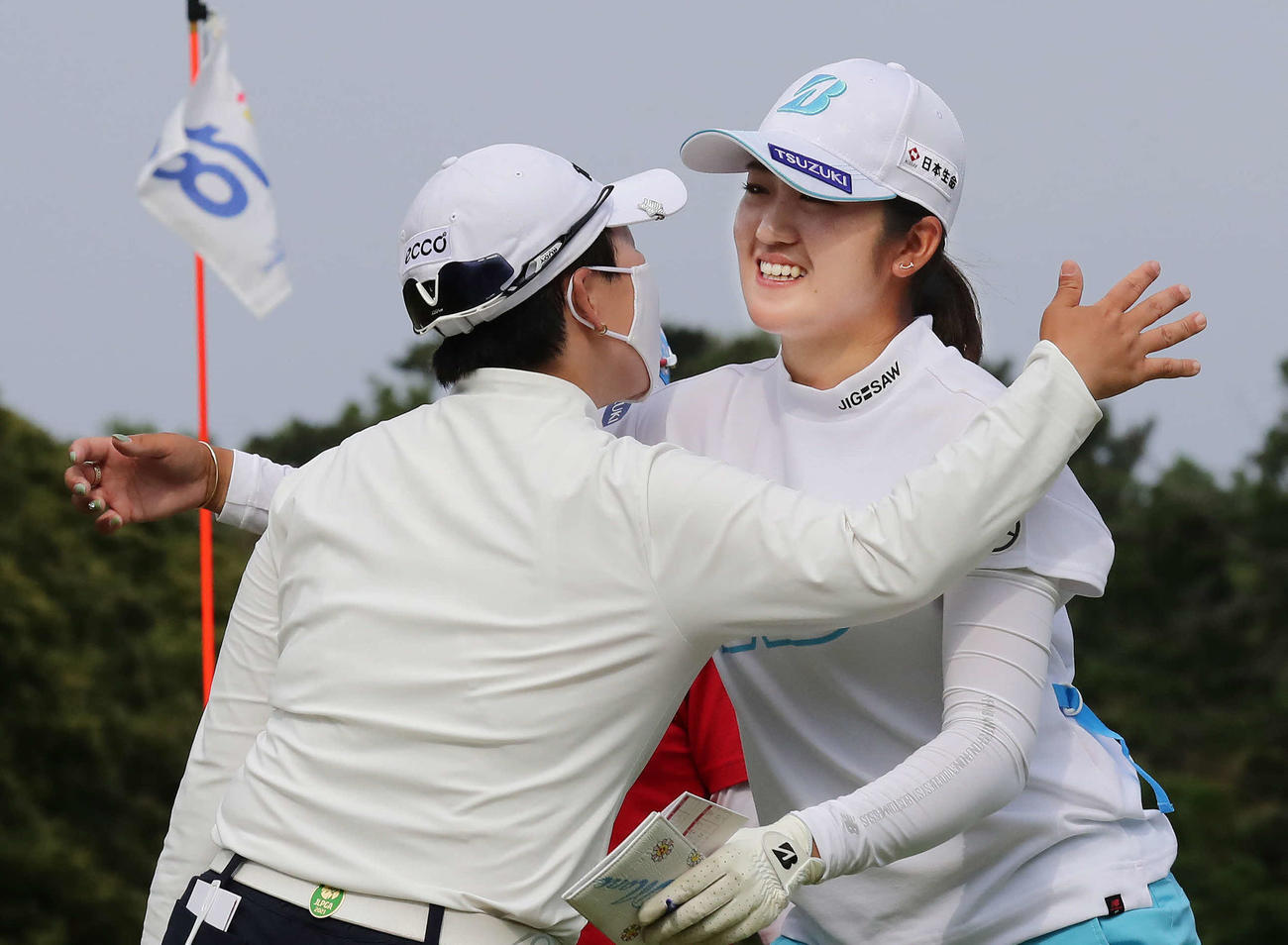 優勝を争った申ジエ（左）の祝福を受ける稲見萌寧（撮影・丹羽敏通）