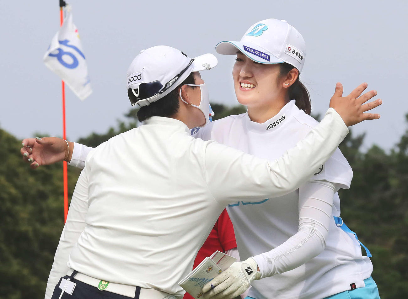 優勝を争った申ジエ（左）の祝福を受ける稲見萌寧（撮影・丹羽敏通）
