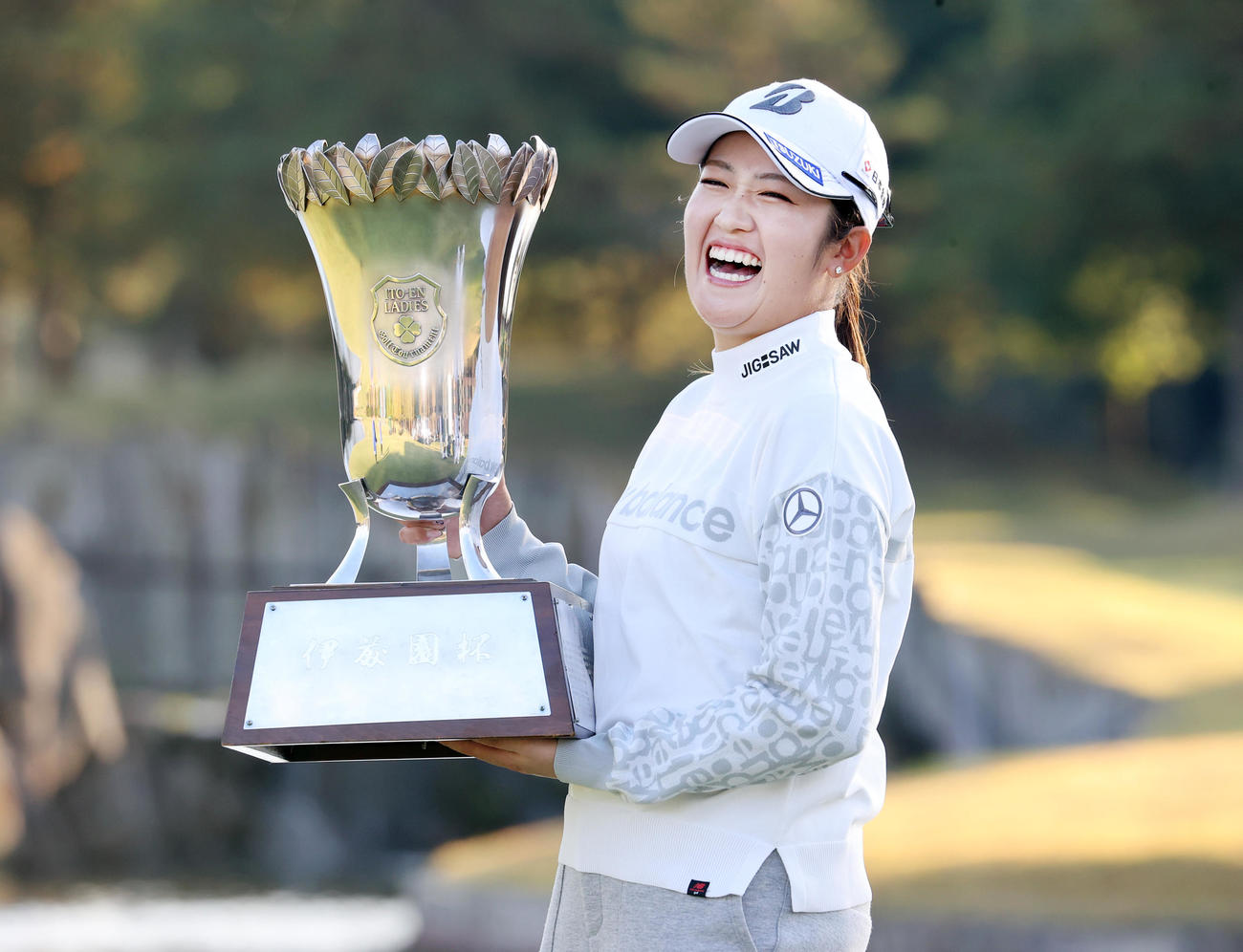 10勝目を挙げた稲見は、優勝杯を手に豪快な笑顔を見せる（撮影・浅見桂子）
