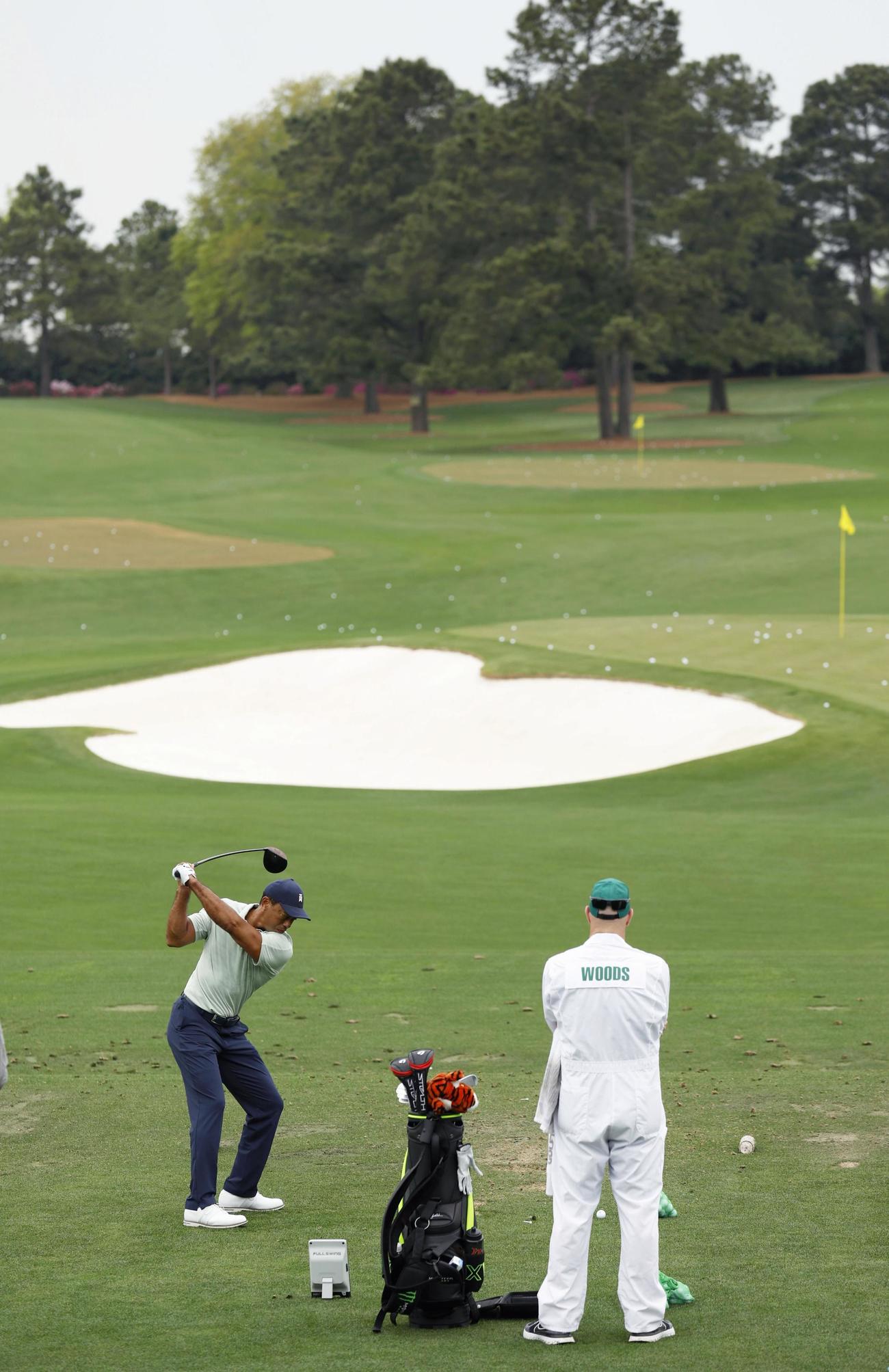 練習場で調整するタイガー・ウッズ（左）＝オーガスタ・ナショナルGC（共同）