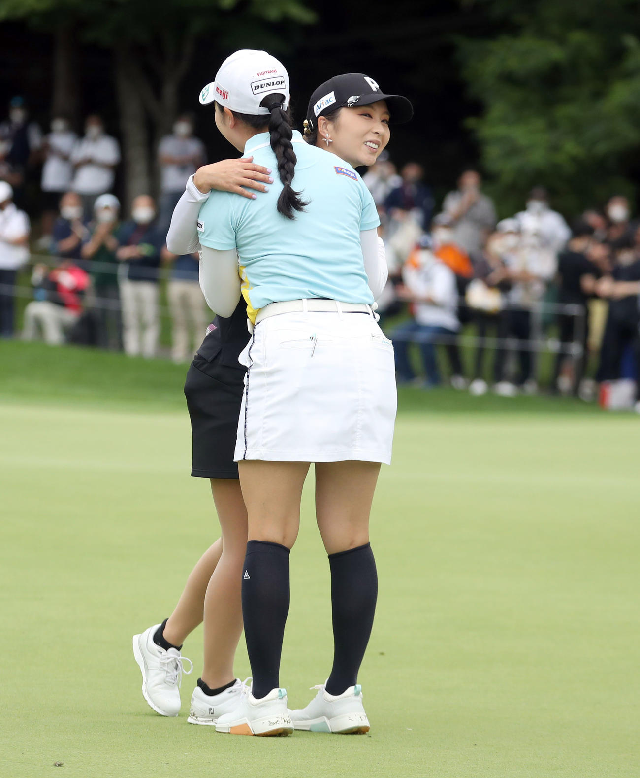 18番、優勝を決めた菊地（左後方）は小祝と抱き合って喜ぶ（撮影・佐藤翔太）