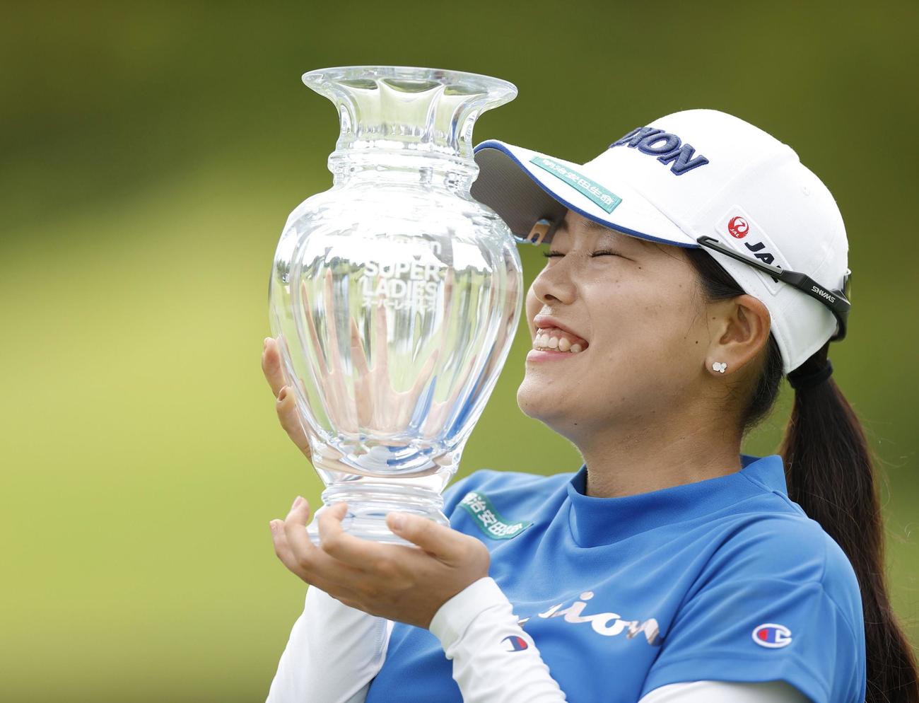 4日間72ホール競技でボギーなしの優勝を果たし、トロフィーを手に笑顔を見せる勝みなみ＝東急グランドオークGC（共同）