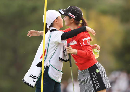 18番、ウイニングパットを沈め、キャディーを務めた森田彩聖さん(左)と抱き合って喜ぶ川崎(撮影・前田充)