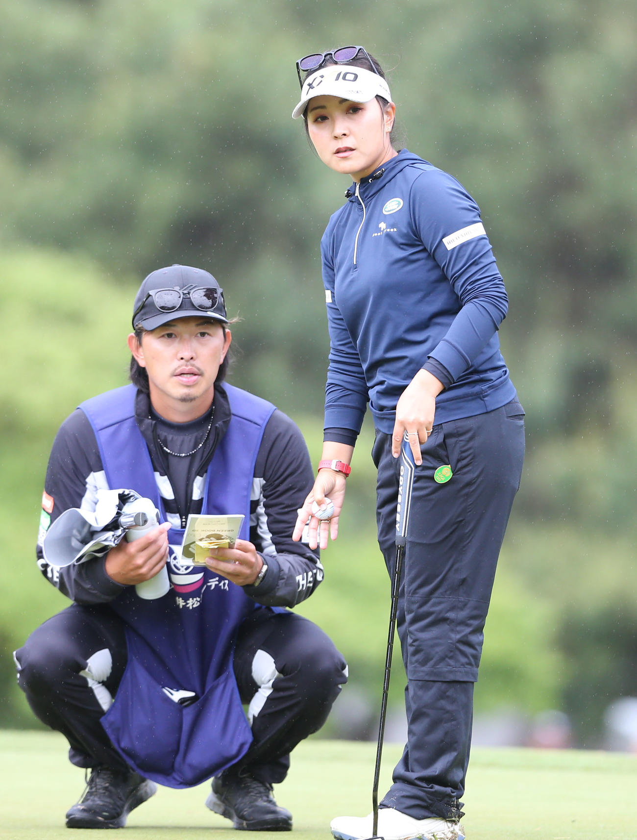 2日目　18番、キャディーとラインを確認する青木(右)（撮影・冨田成美）