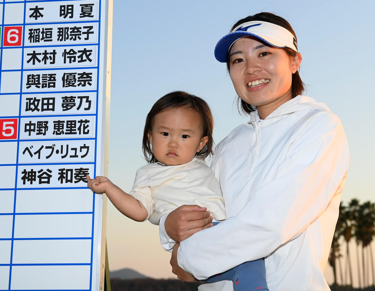 愛娘の咲凜ちゃんが合格者ボードのママの名前を指さし笑顔を見せる神谷和（撮影・前岡正明）