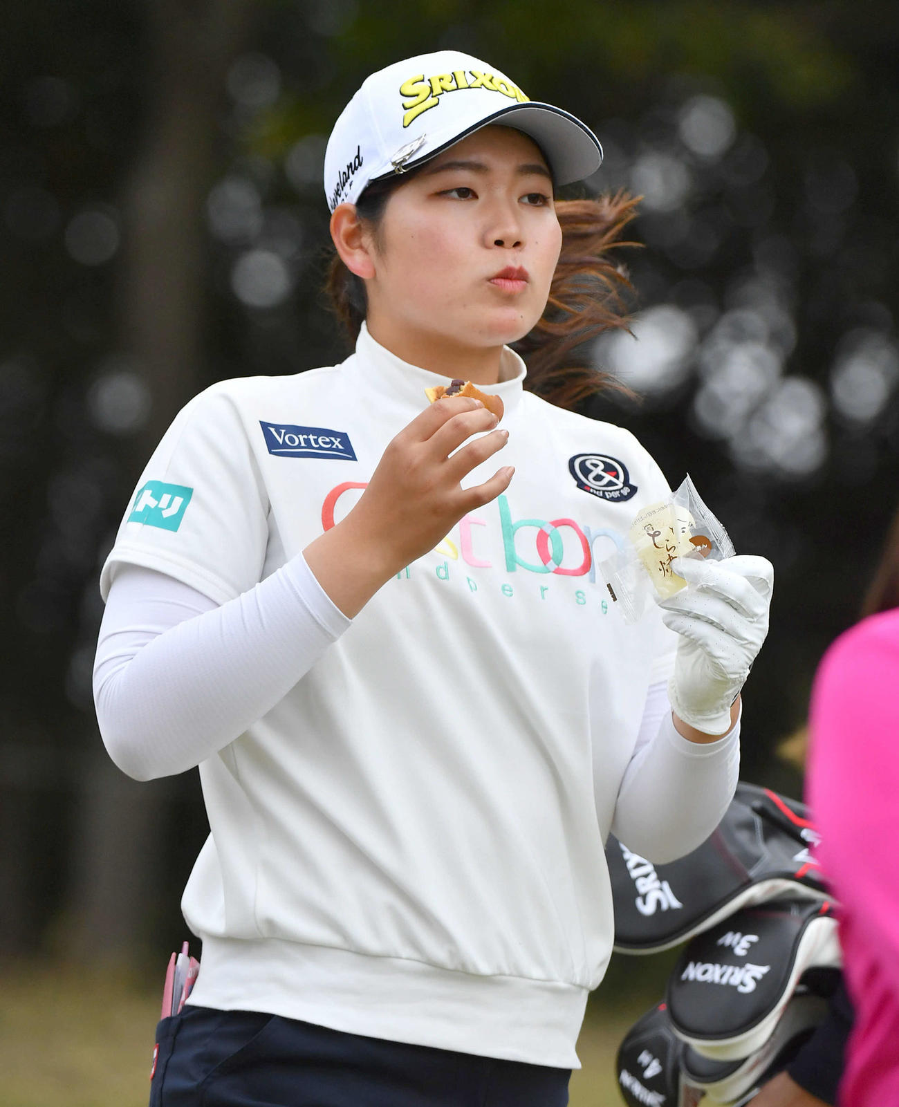 アクサレディス宮崎2日目　9番、どら焼きで栄養補給をしながら第2打へ向かう桜井心那（撮影・岩下翔太）
