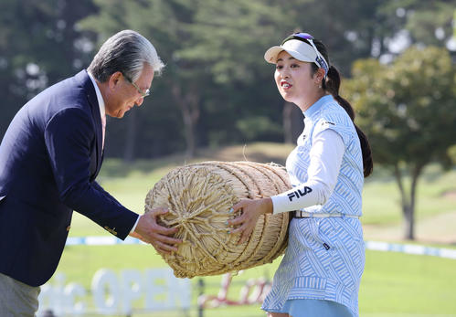 初優勝した天本は副賞の米俵を重そうに受け取る（撮影・宮地輝）