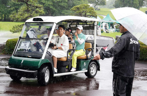 雨天のため競技が一時中断となり、カートでクラブハウスに引き揚げてくる選手たち（撮影・小沢裕）