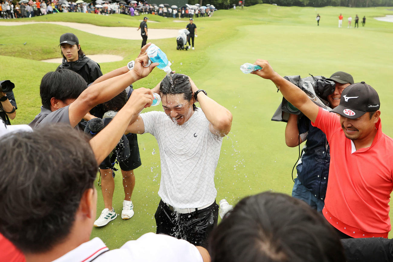 優勝し選手たちから水をかけられ祝福を受ける石川（撮影・鈴木正人）