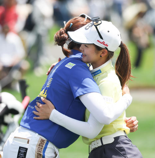9番、ホールアウトし原（左）と抱き合う川崎（撮影・佐藤翔太）