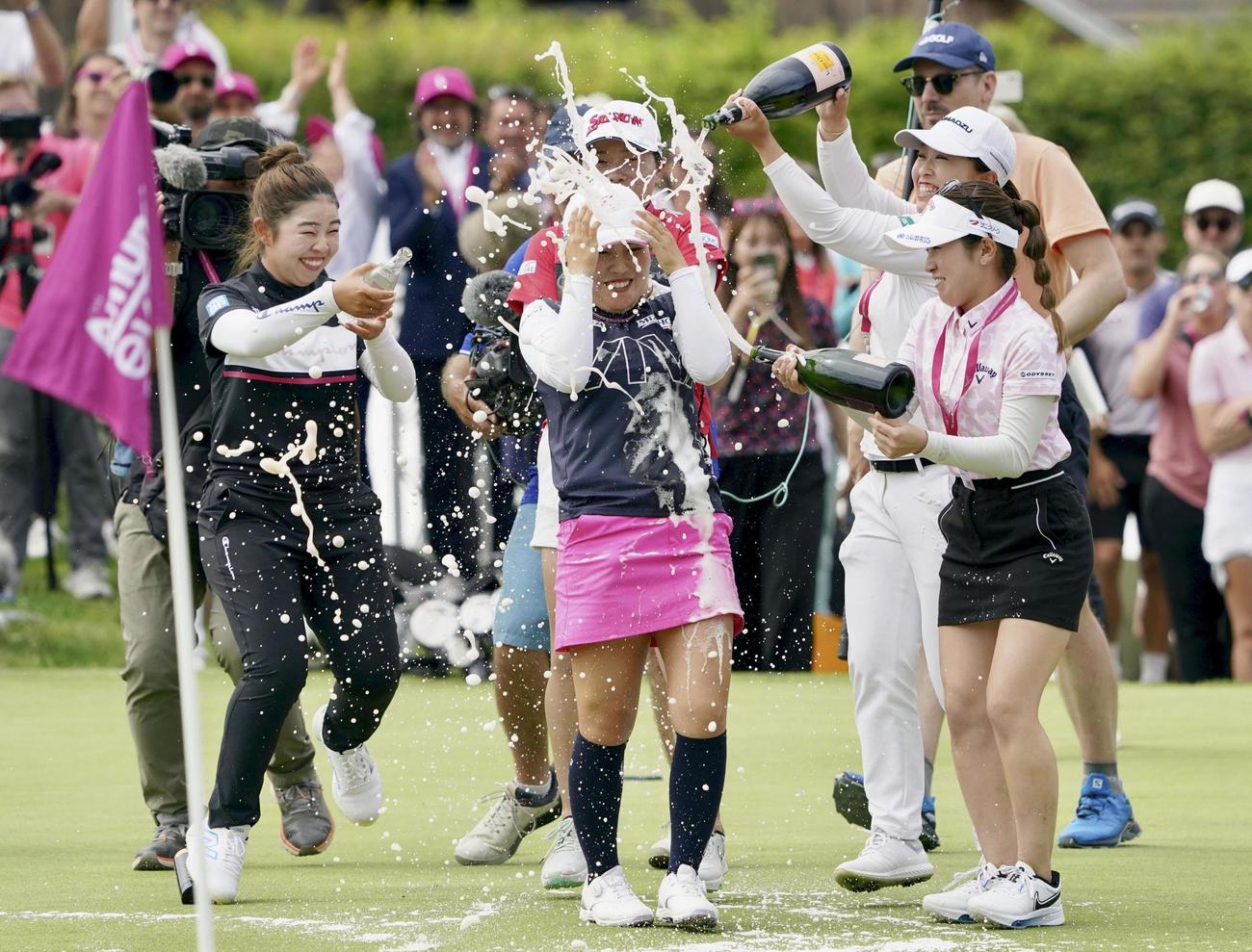 最終ラウンド、通算19アンダーで優勝し、山下（左端）らからシャンパンで祝福される古江（中央）（共同）