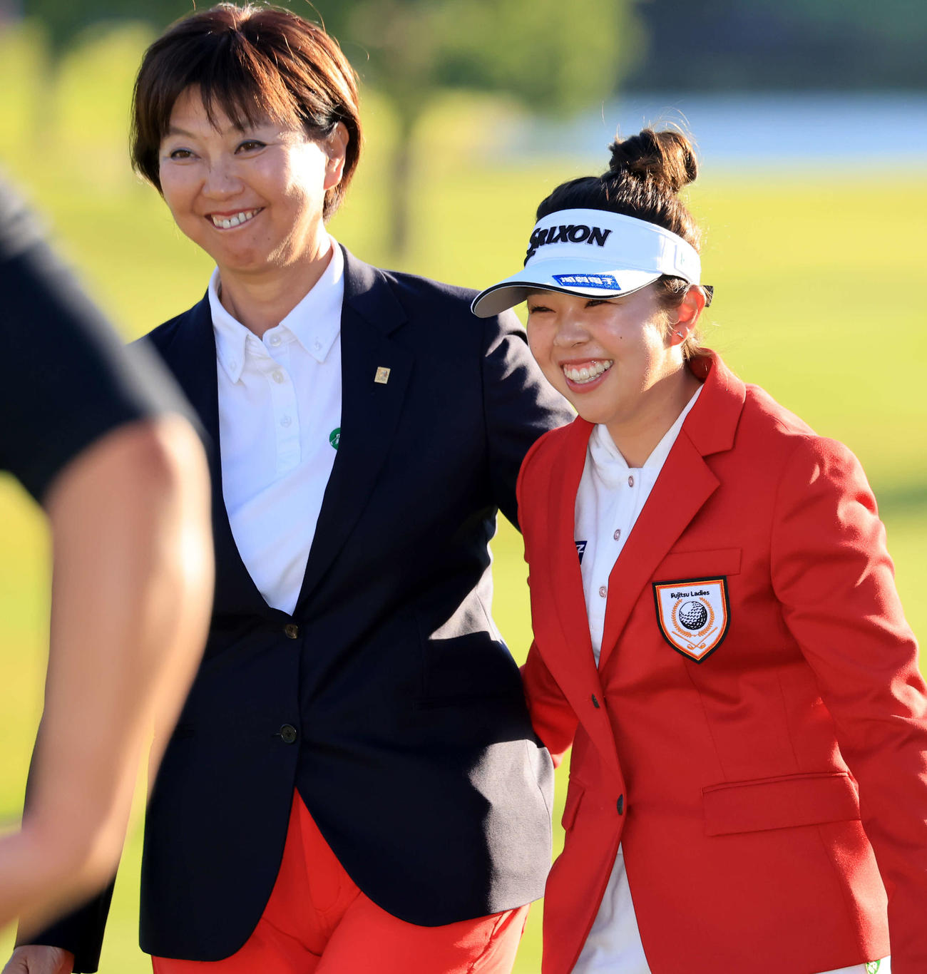 今季初優勝を決め、小林会長（左）から祝福され笑顔の山下（撮影・浅見桂子）