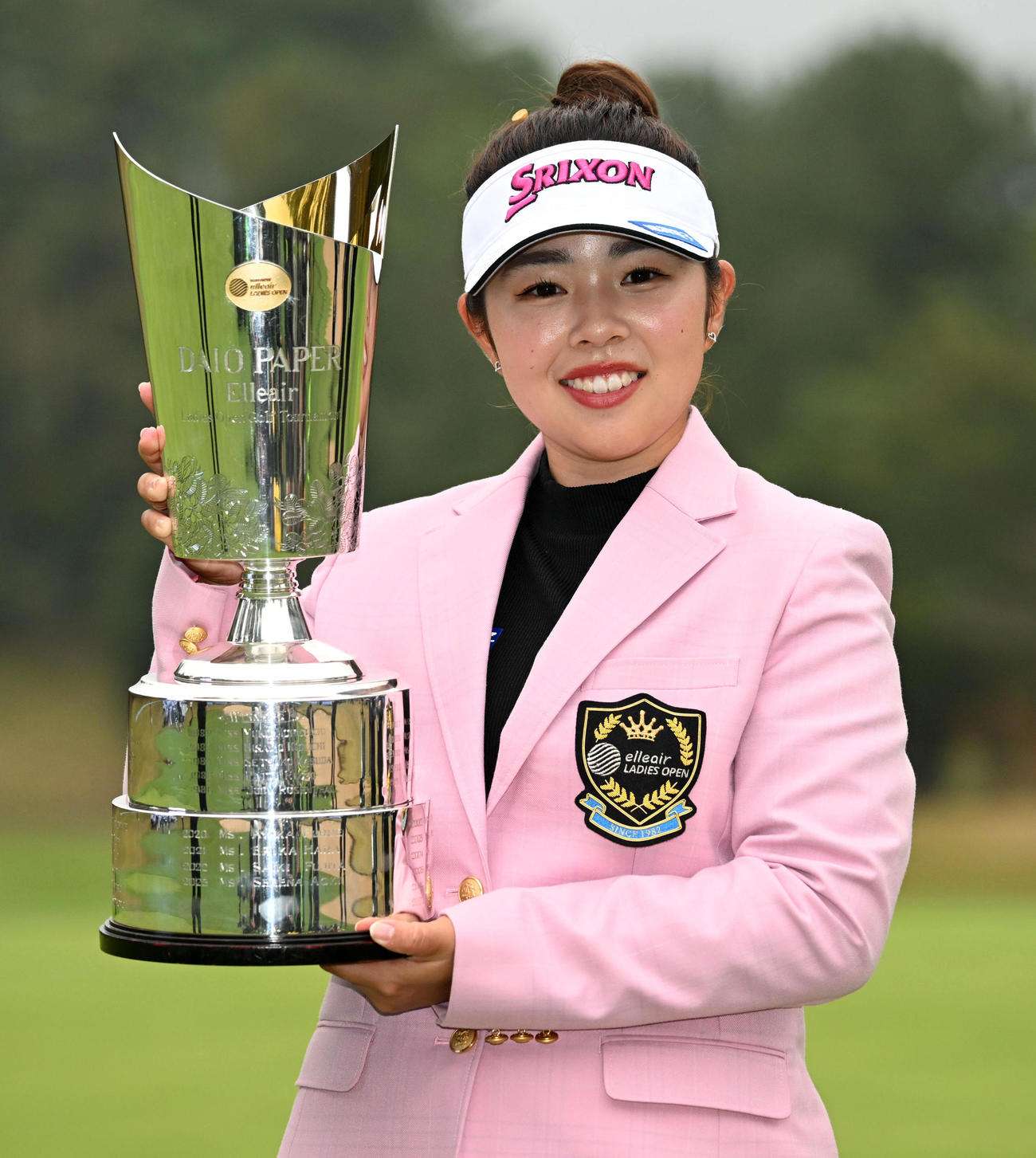 優勝カップを手に笑顔を見せる山下（撮影・前岡正明）