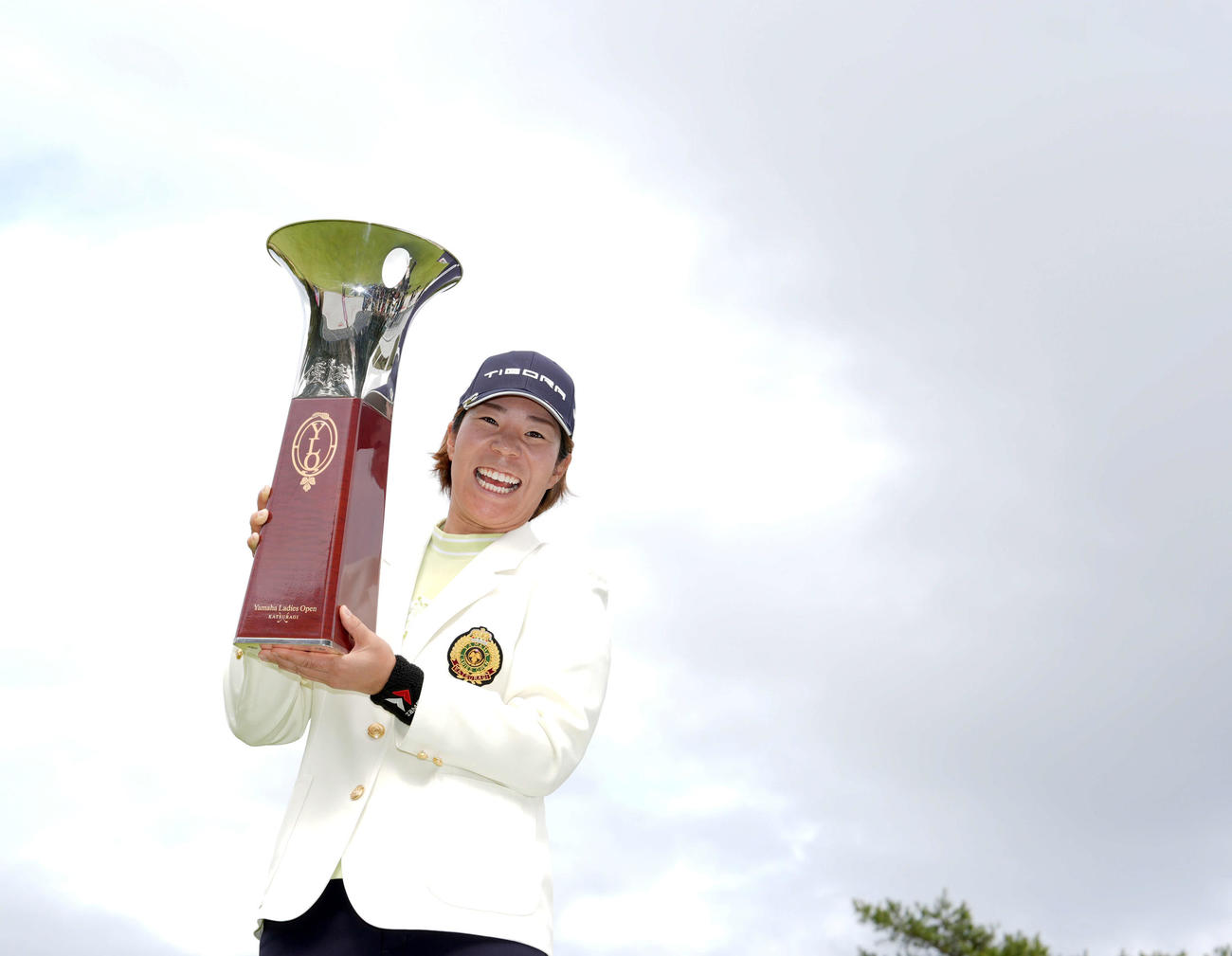 今大会2度目の優勝を飾った穴井は、トロフィーを手に笑顔を見せる（撮影・たえ見朱実）