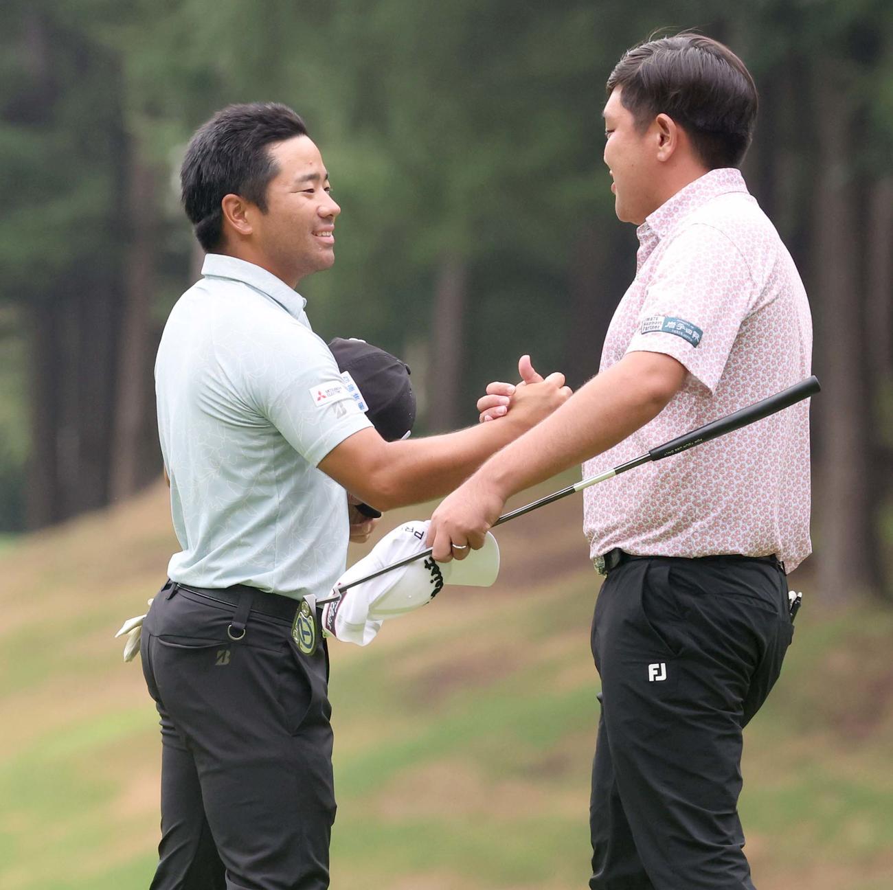 プレーオフで優勝を争った米沢（右）と笑顔で握手する比嘉（撮影・黒川智章）