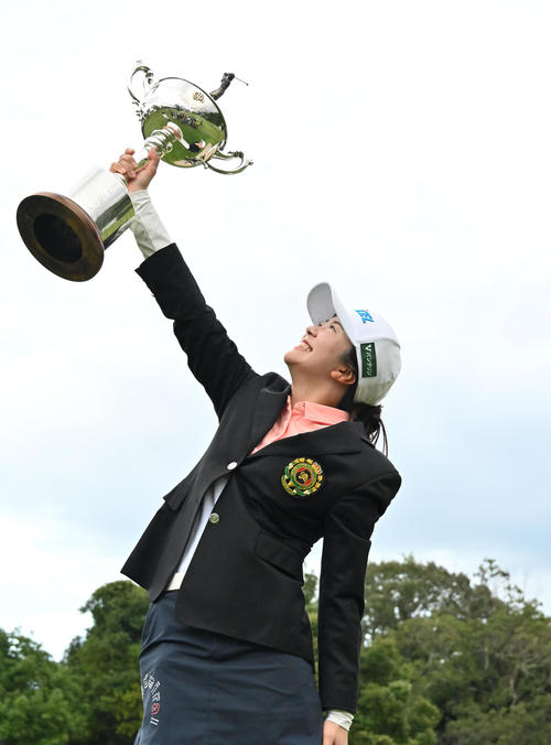 優勝トロフィーを高々と掲げる堀（撮影・石井愛子）