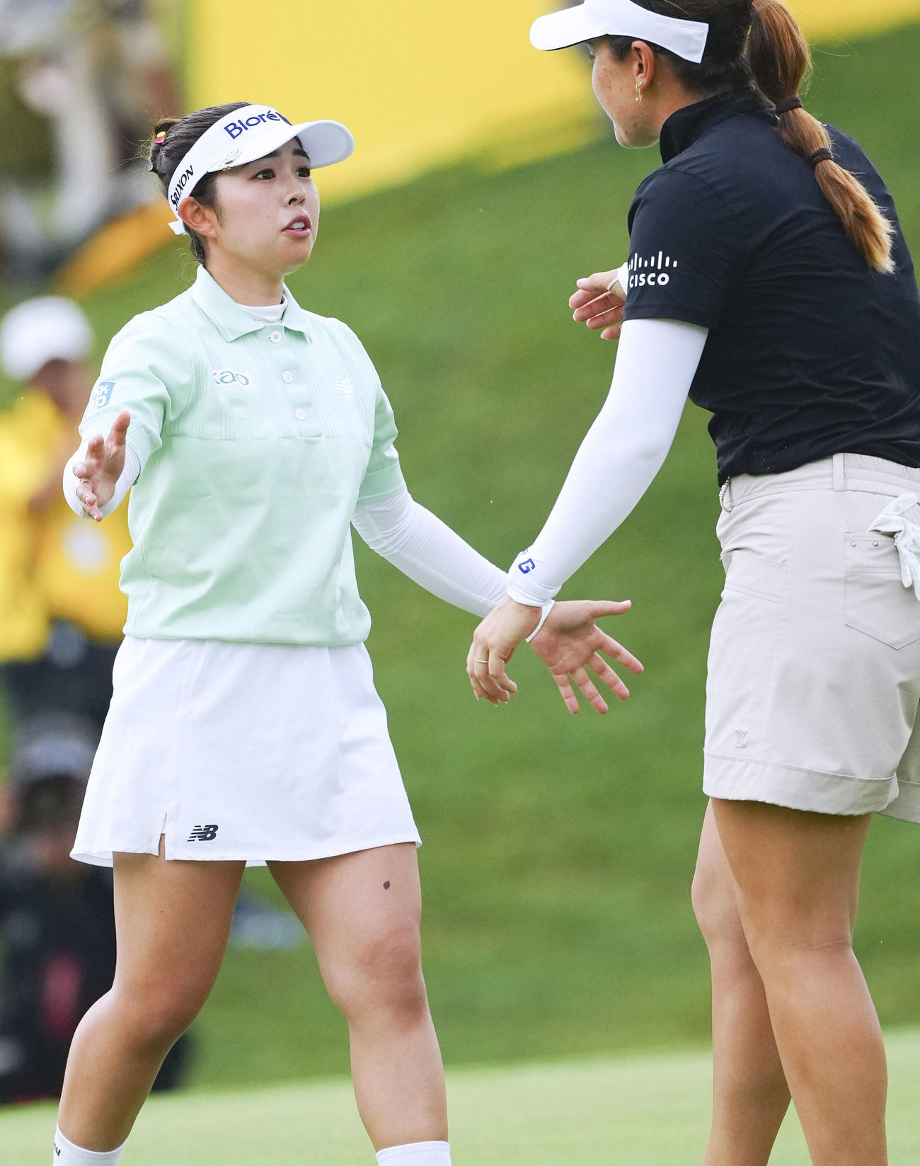 最終ラウンド、プレーオフを戦ったハンナ・グリーン（右）にあいさつする山下美夢有（共同）