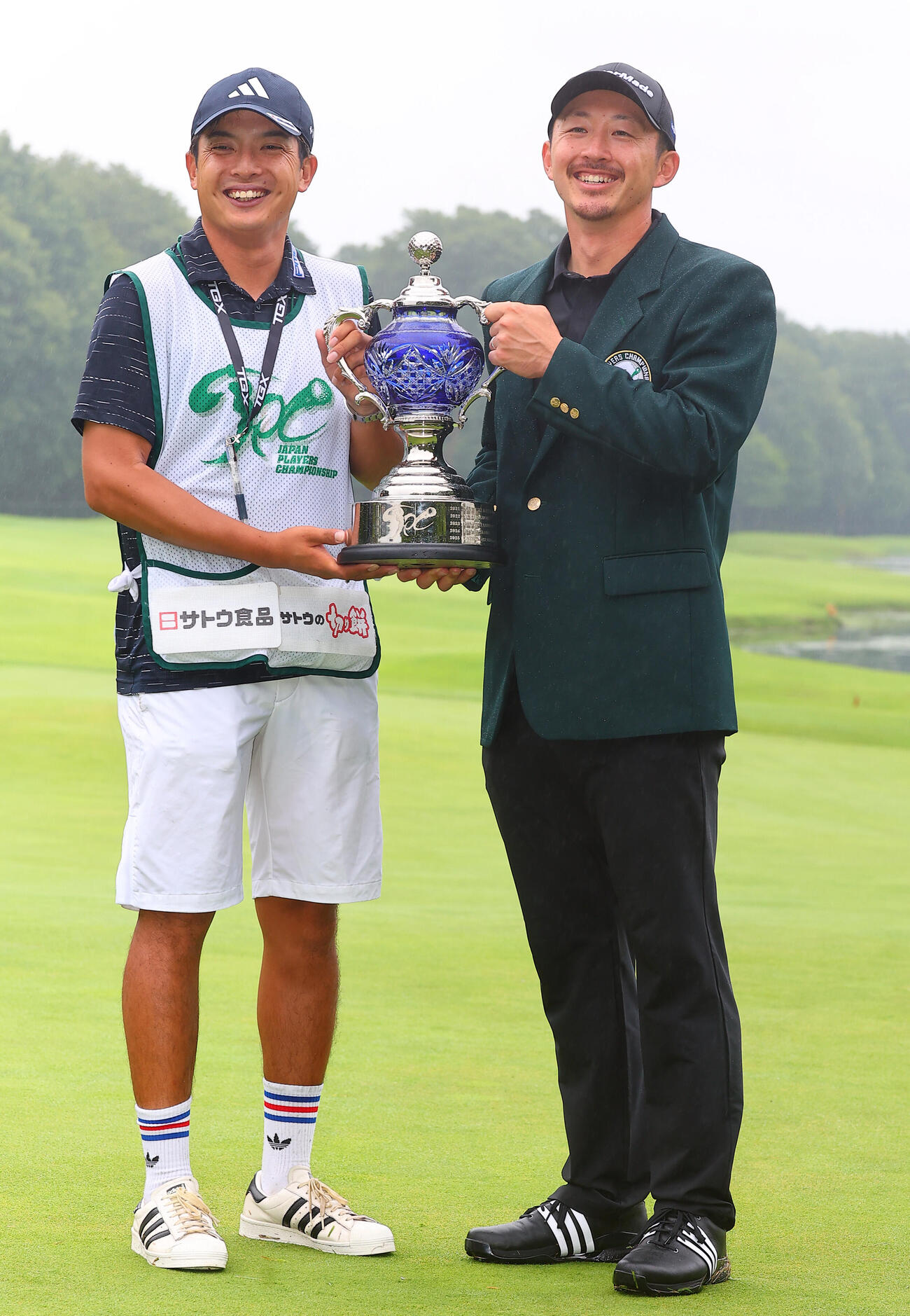 優勝し、湯本キャディー（左）と喜ぶ岩崎亜久竜（撮影・野上伸悟）