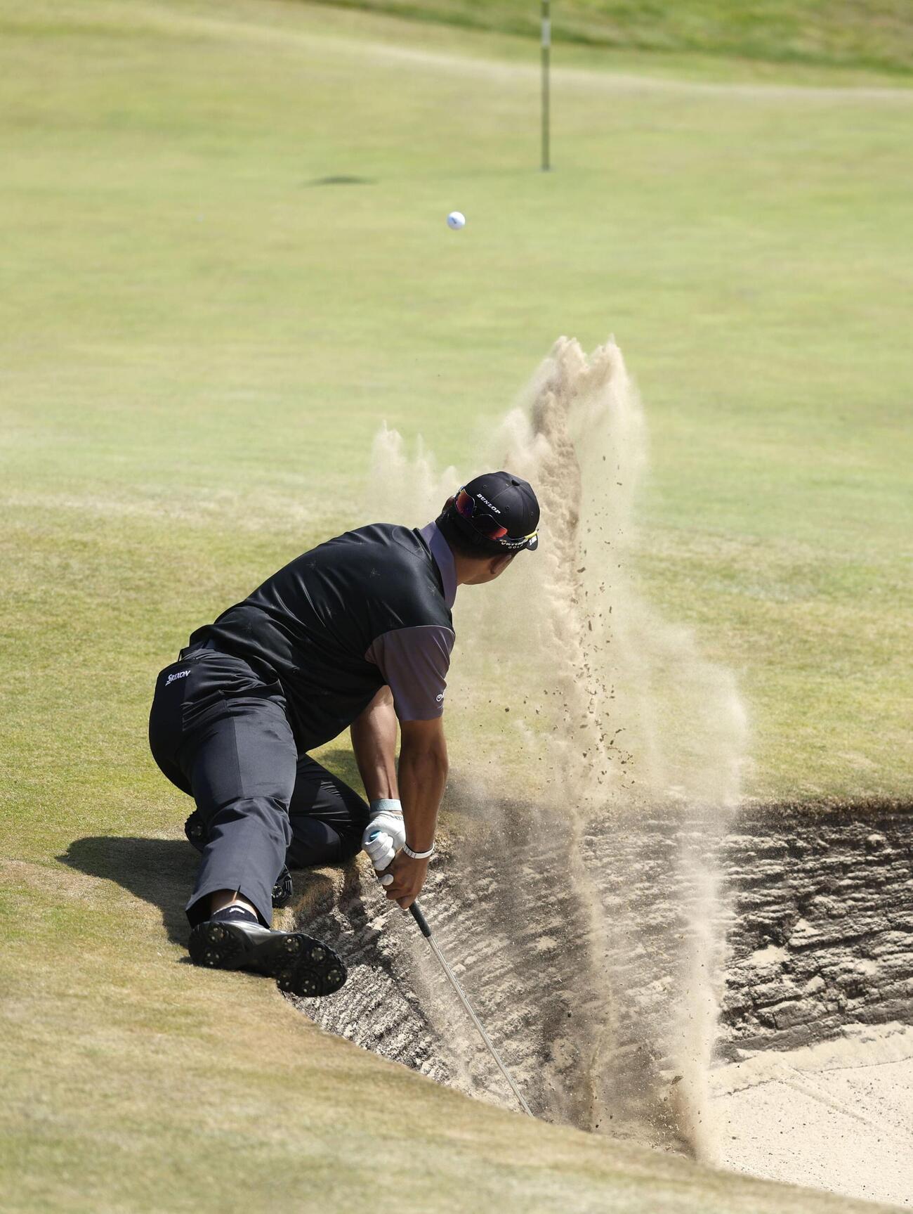 第1ラウンド、17番でバンカーショットを放つ松山英樹＝ロイヤルバークデールGC（共同）