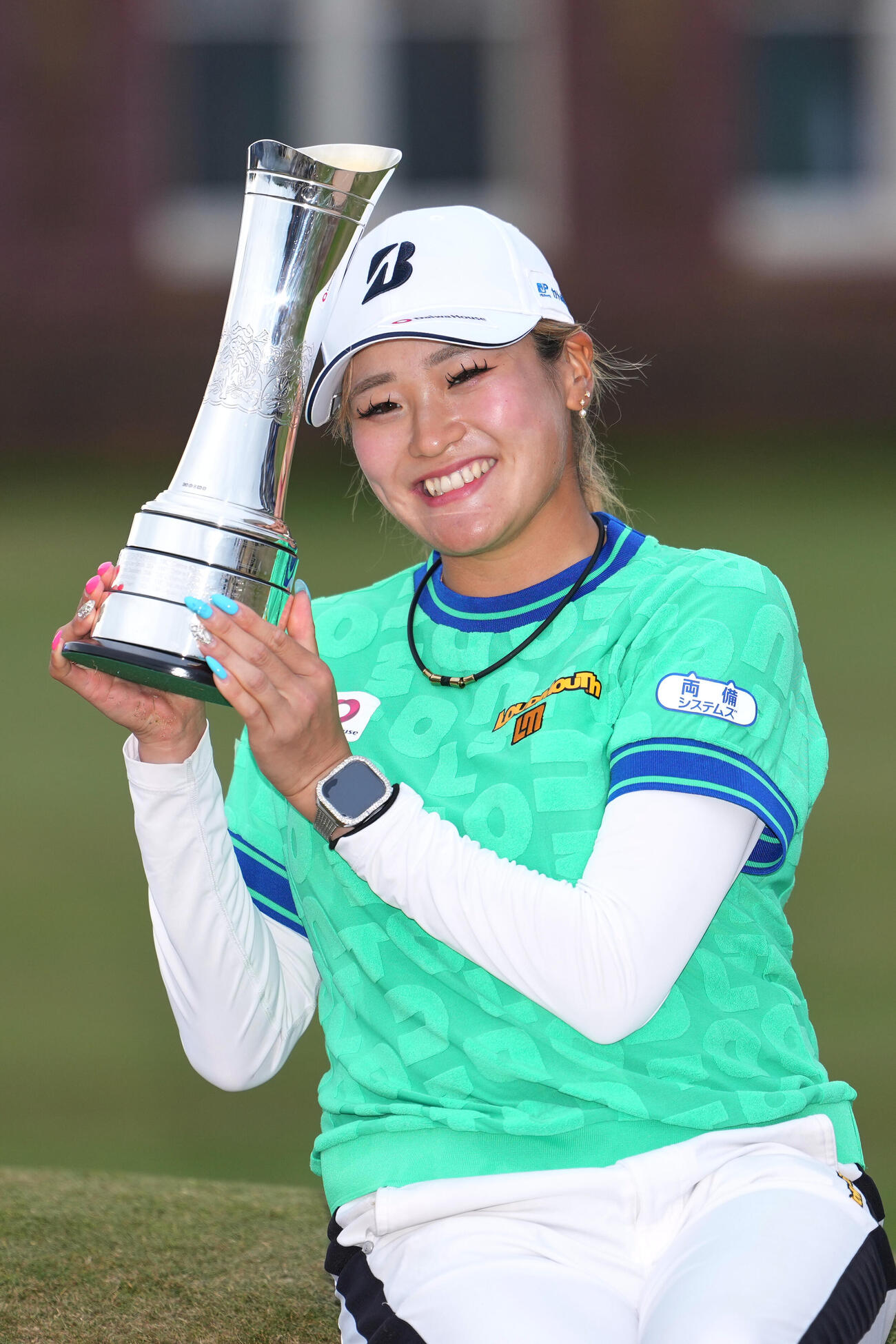 全英女子オープンで優勝しトロフィーを手に笑顔を見せる桑木志帆（AP）