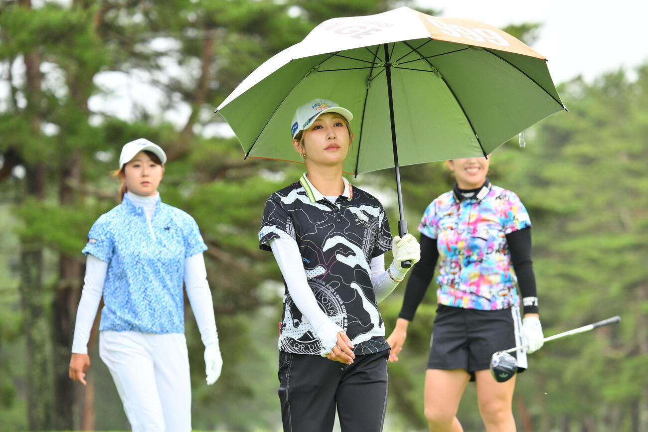 4番、日傘をさしてラウンドする金田久美子（撮影・滝沢徹郎）