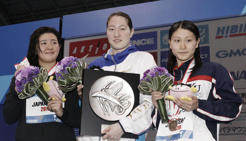 女子100メートル背泳ぎ表彰式　優勝の酒井（中央）2位の諸貫（左）3位の古林（撮影・河田真司）