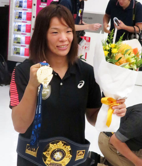 女子57キロ級で優勝した川井梨紗子は帰国後、金メダルを掲げて撮影に応じる（撮影・松熊洋介）