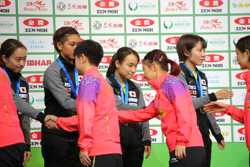 表彰式で優勝した中国代表チーム（手前）と握手を交わす準優勝の日本代表チーム（撮影・河田真司）
