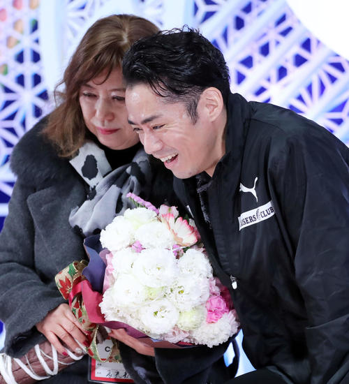 男子フリーの演技を終えた高橋大輔(右)は長光歌子コーチに花束を渡し笑顔を見せる(撮影・垰建太)