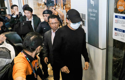 空港に到着した桃田賢斗選手（手前右）（共同）