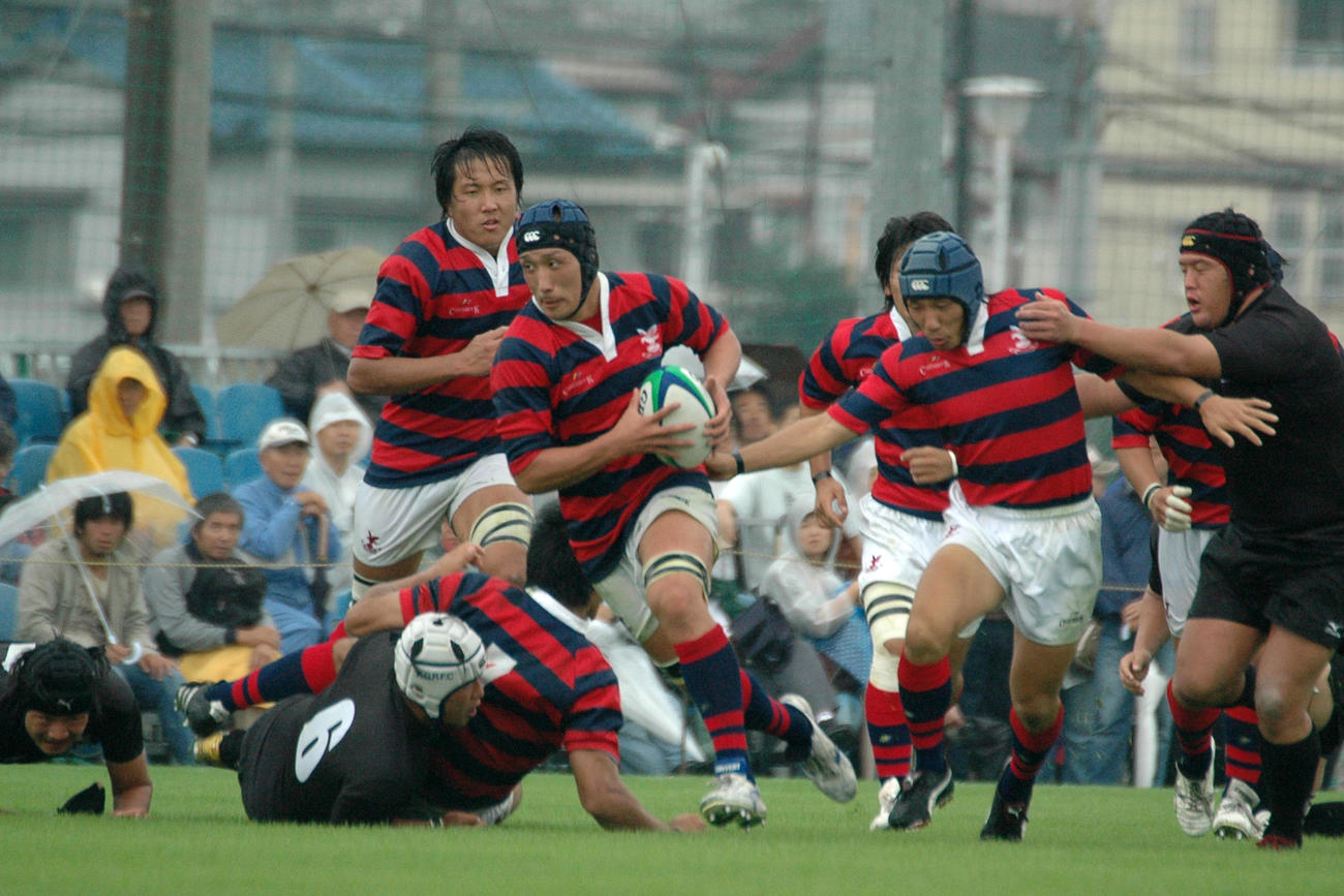 08年10月、天理大とのリーグ戦で突破する京産大時代の中井さん（中央）（京産大ラグビー部提供）