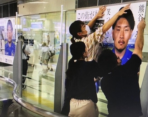JR熊谷駅に増刷した稲垣啓太のポスターを貼るスタッフら（熊谷商工会議所提供）