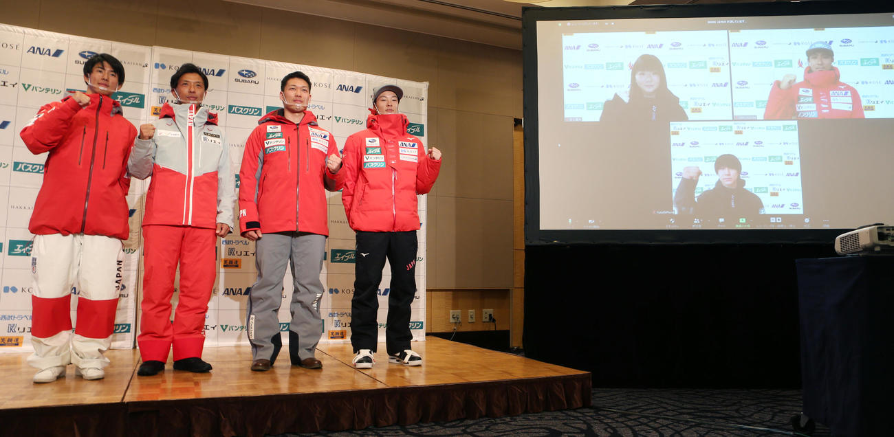 全日本スキー連盟の会見で今季の公式ユニホームを着てポーズをとる左からフリースタイル・モーグルの堀島、ナショナルデモンストレーターの丸山、フリースタイルスキークロスの須貝、ジャンプの小林、スクリスーン右上から時計回りにノルディック複合の渡部、スノーボード・ハーフパイプの戸塚、スノーボード・スロープスタイル／ビッグエアの岩渕（撮影・野上伸悟）